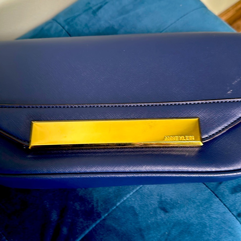Gently used Anne Klein navy cross body handbag with inside and outside pockets